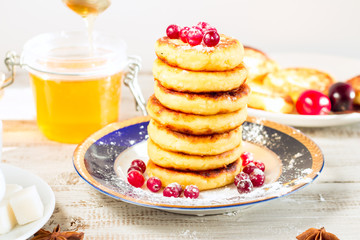 Delicious cottage cheese pancakes with honey and cranberries.