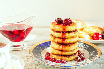 Delicious cottage cheese pancakes with cherry jam and cranberrie