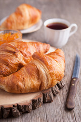 Three croissants on the dark wooden table, selective focus
