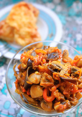 Plates of tasty ragout from vegetables and mushrooms.