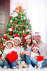 Obraz na płótnie Canvas Happy family near Christmas tree