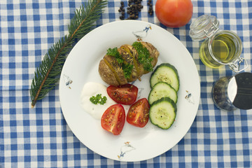 a baked potatoe with vegetables