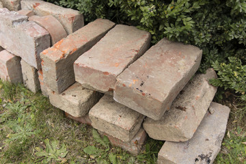 Several bricks lying on the grass