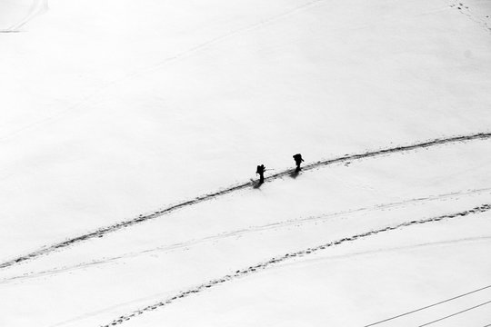 Two mountaineers walking across Mont Blanc high mountain range in Chamonix, France