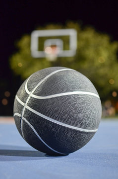 Basketball on the court at night