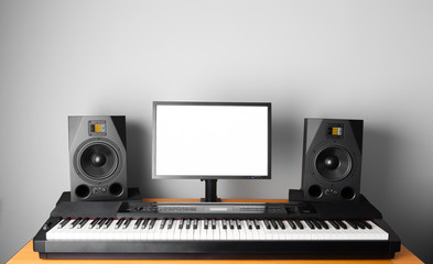 digital audio workstation (daw) studio with electronic piano and monitor speakers