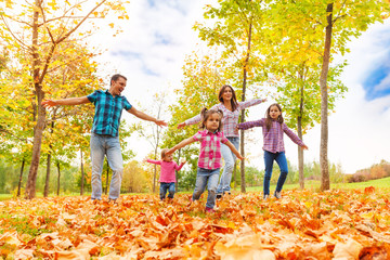 Family with many kids run in autumn park