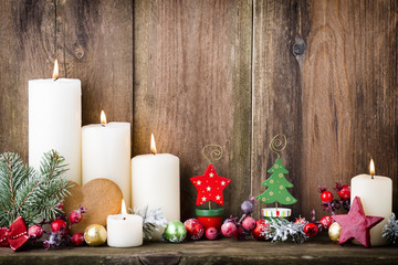 Christmas Advent candles with festive decor.