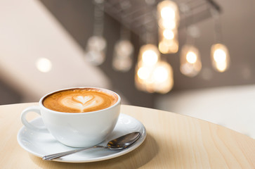 Hot art Latte Coffee in a cup on wooden table and Coffee shop bl
