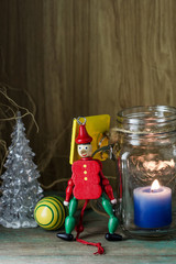 Wooden toy soldier in red uniform decoration and candle