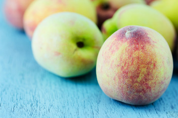 group of fresh peaches on wood background