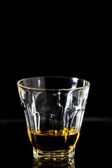 Glasses of whiskey on wood background.
