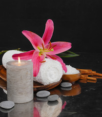 Spa feeling with towel ,candle ,salt in bowl , pebbles, pink lily