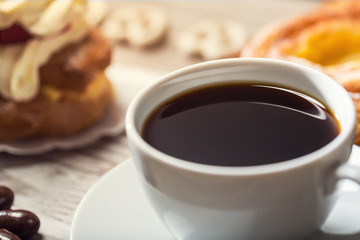 Cup of coffee with assorted desserts