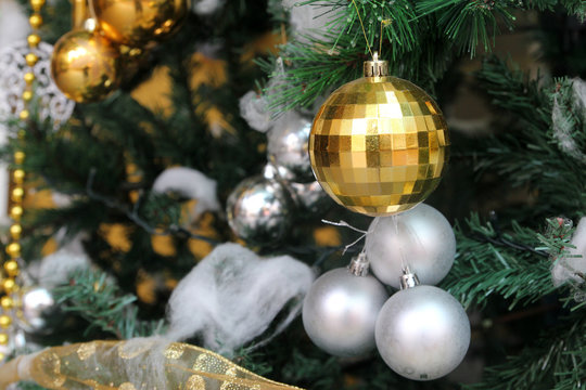 White And Yellow Christmas Tree Ball Ornaments On Tree