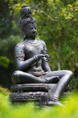 Fototapeta na wymiar Bronze statue Bodhisattva in the garden