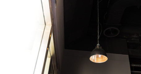 hanging lamps on black ceiling with sunlight exterior