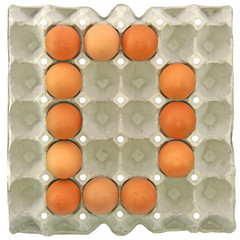 A letter D from the eggs in paper tray