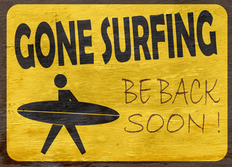 gone surfing sign on wood grain texture