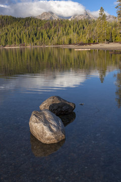 Rocks in shallow lake on sunny day.