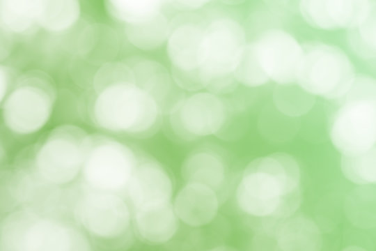 Green bokeh glitter defocused lights abstract background.