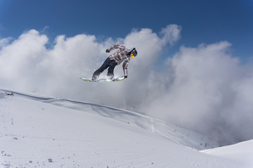 Flying snowboarder on mountains, extreme sport
