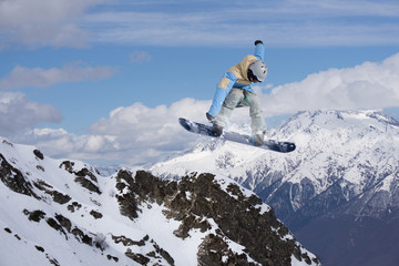 Flying snowboarder on mountains, extreme sport