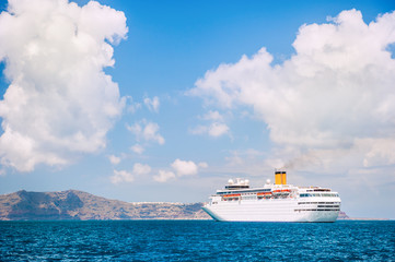 Big cruise ship at the sea near the islands.