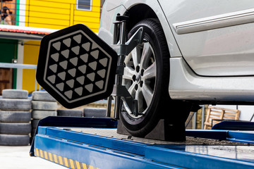 Car wheel fixed with computerized wheel alignment machine clamp