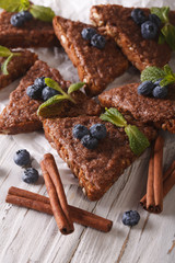 Toasts with cinnamon, mint and blueberries on a table macro. vertical
