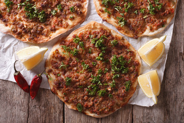 Asian pizza lahmacun closeup on a wooden table. horizontal top view 
