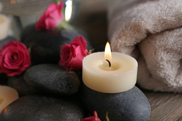 Spa composition of candles, flowers and stones, close-up