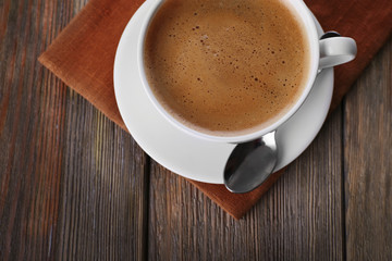 Cup of coffee on brown napkin closeup