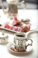 Antique tea-set with Turkish delight on table close-up