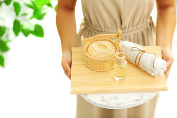 Female hands with tray of spa products, at spa salon