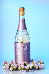 Decorated wedding bottle of champagne with roses isolated