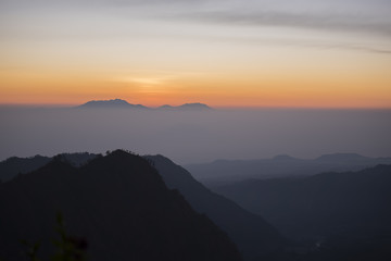 Fototapeta premium Foggy and volcano mountain during sunrise taken from Pinajagun II view point ,Indonesia. 