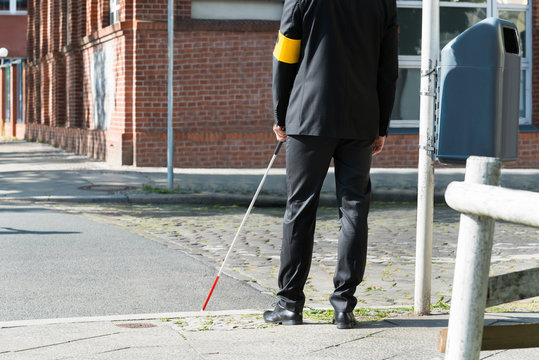 Blind Man With White Stick On Street