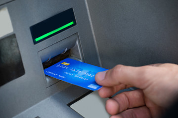 Man's Hand Using Atm