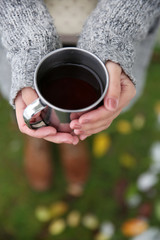 Obraz na płótnie Canvas Hand holding coffee cup, outdoors