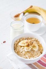 Autumn oatmeal in white bowl banana honey