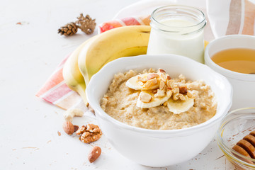 Autumn oatmeal in white bowl banana honey