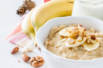 Autumn oatmeal in white bowl banana honey