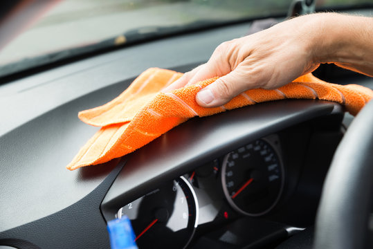 Male Worker Cleaning Car Dashboard