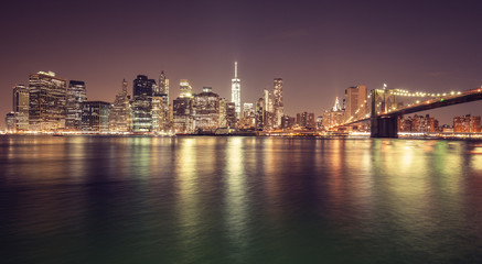 Obraz na płótnie Canvas Vintage toned Manhattan waterfront at night, NYC, USA.