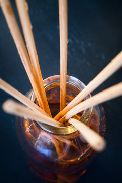 Macro shot of sticks in aroma reed diffuser. Toned image.