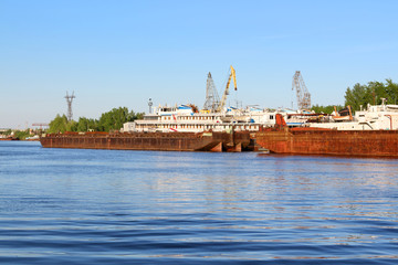 Fototapeta premium Old rusty freight ships, cranes for loading and passenger liner