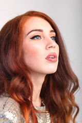 Fototapeta premium Portrait beautiful young girl with red hair with her mouth open
