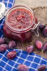 Jars plum jam wooden table