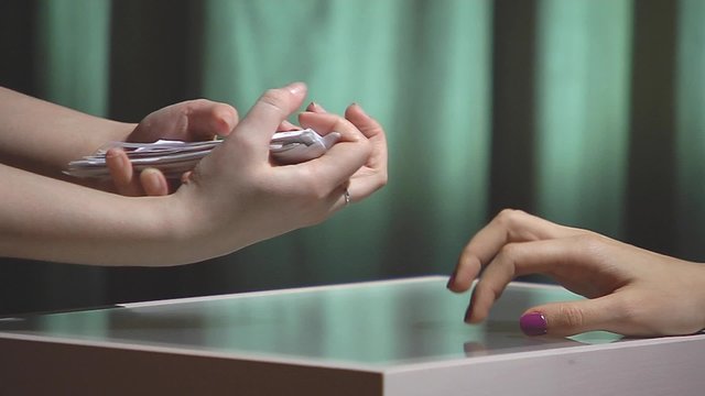 Female hand calculate with reference rubles and give a woman.